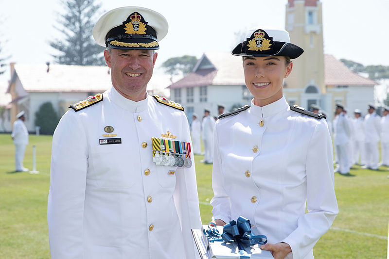 Commodore Justin Jones, CSC, RAN, presents Midshipman Tessa English, RAN, with the Australian Naval Institute Sea Training Deployment Prize. 
