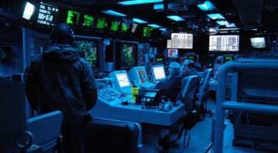 The Arabian Gulf (Mar. 23, 2003) — The Tactical Operations Officer (TAO), along with Operations Specialists, stand watch in the Combat Direction Center (CDC) aboard the aircraft carrier USS Abraham Lincoln (CVN 72) monitoring all surface and aerial contacts in the operating area.  (U.S. Navy photo by Photographer’s Mate Airman Tiffany A. Aiken)