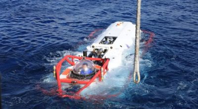 A sailor from the Chinese navy submarine rescue ship Changdao (867) sits in an LR-7 submersible undersea rescue vehicle off the coast of Hawaii following a successful mating evolution between the LR-7 and a U.S. faux-NATO rescue seat laid by USNS Safeguard (T-ARS-50), during Rim of the Pacific 2016. The evolution was the final event and practical portion of a multinational submarine rescue exercise between seven countries.