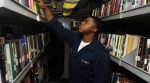 US_Navy_100130-N-6604E-006_Logistics_Specialist_Seaman_Joshua_Williams_browses_through_books_in_the_ships_library_aboard_the_aircraft_carrier_USS_Dwight-1038x576