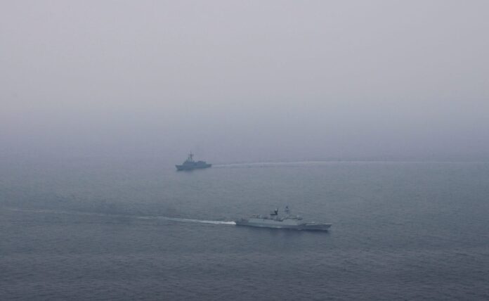Chinese navy ship Xianning (foreground) and HMAS Melbourne during a passage exercise: Department of Defence.