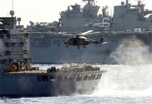 HMAS Canberra chopper prepares to take a load