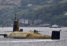 Submarine arrives caked in algae